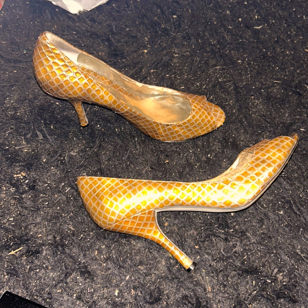 Size 9.5 Italian Enzo Angiolini gold peep toe high heels in used condition.